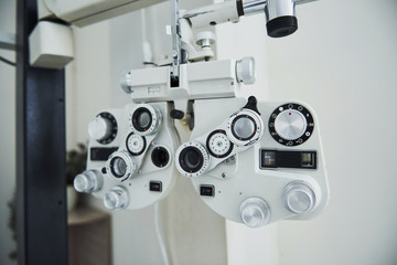 Fototapeta na wymiar Phoropter standing in the office. Ophthalmologist devices in the beautiful white room
