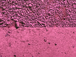Horizontal divided pink surface with pebbles at the top