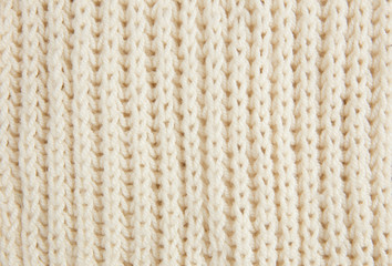 White knitted woolen fabric textile background. Vertical lines.