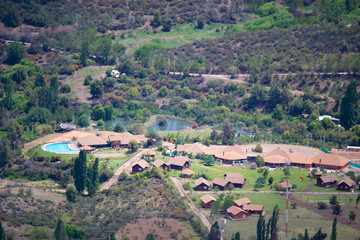 Fototapeta na wymiar view of the valley between the mountains. view from above. to a residential valley. around the chilean mountains. below the village and ponds