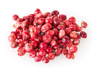 Heap of pink peppercorns isolated on white background
