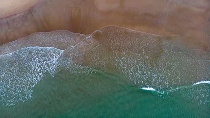 Fotobehang Beautiful aerial view of a beach with waves © Gelpi