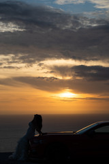 Obraz na płótnie Canvas Woman with her car at dusk