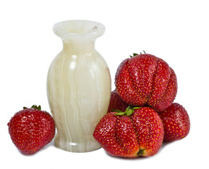 strawberry, ripe red berries and marble vase..