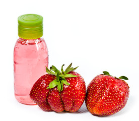 strawberry, ripe berries and cosmetic bottle