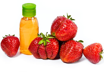 strawberry, ripe berries and cosmetic bottle