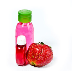 strawberry, ripe berries and cosmetic bottle