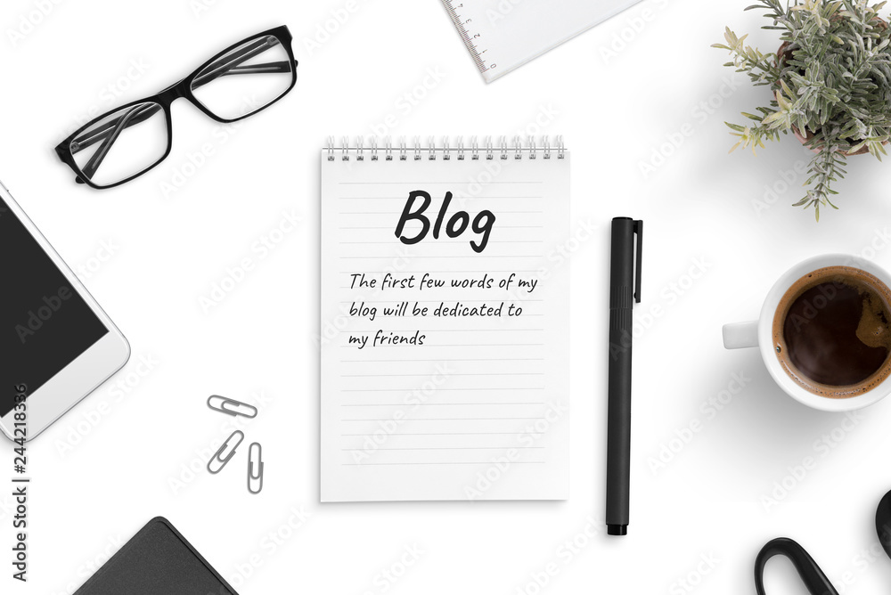 Poster concept of blogging and freelancing. a few blog words on a pad paper on office desk.
