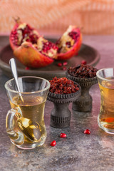 Different varieties of Shisha Smoking hookah. Black annealed ceramic bowl for hookah in the background of tea cups and the open pomegranate.