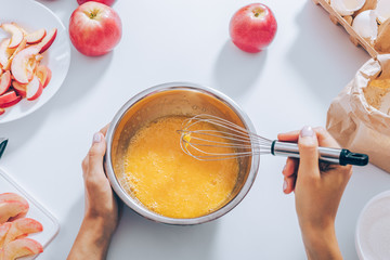 Flat lay arrangement woman cooking fruit cake