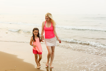 mother and daughter happy in love at sunset