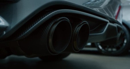 Close up of details of muffler of anonymous prestigious luxury modern car. Shot in 8K. Concept of passion for driving cars and engines, car dealerships, used cars,luxury cars, auto dial