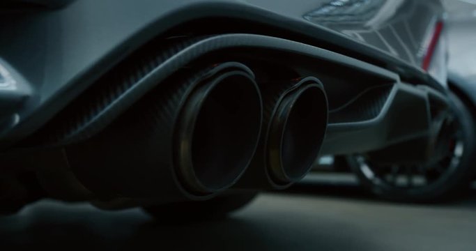 Close up of details of muffler of anonymous prestigious luxury modern car. Shot in 8K. Concept of passion for driving cars and engines, car dealerships, used cars,luxury cars, auto dial