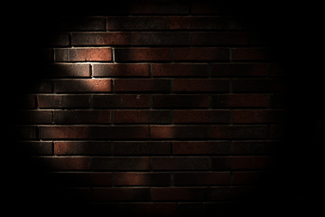 dark brick background with falling sun rays. Copy space