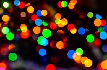 Close-up of the magical shine of the Christmas lights of the reflections from the garlands. Fairy dream