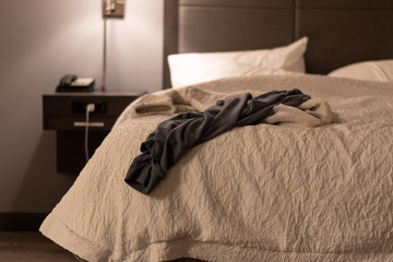 Clothes thrown on a bed