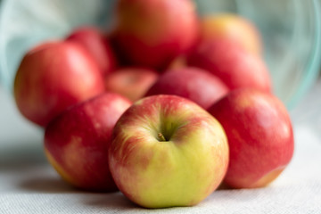 A bowl of apples that spilled over