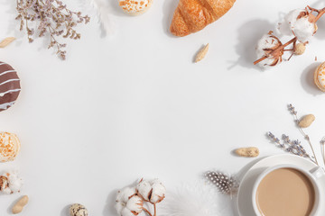 A cup of coffee with milk. Composition with lavender, nuts on a light background.