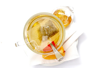 cup of tea, honey and lemon on white