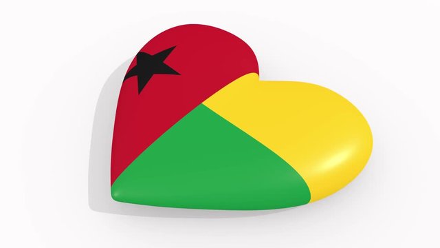 Heart in colors and symbols of Guinea-Bissau on white background, loop
