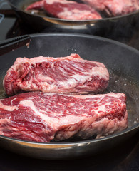 Raw steak on the pan
