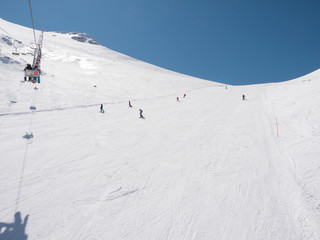 Skiers and snowboarders in a slope