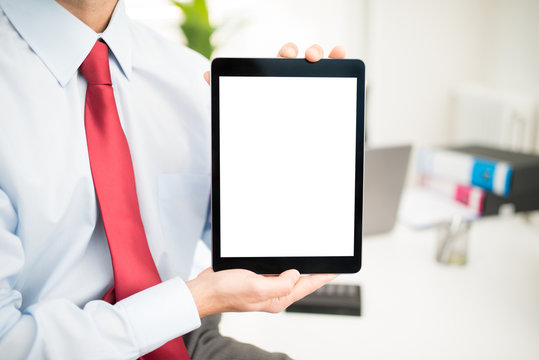 Man holding a tabletin his office