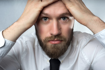 Close up of young bearded businessman
