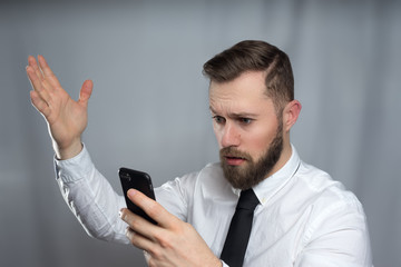 Young bearded business men looking unhappy to his phone