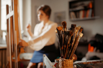 Brushes collection, female artist on background