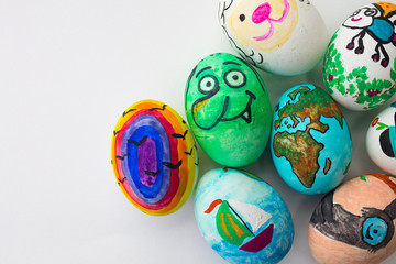 Detail of painted Easter eggs with different forms, cartoons and bright colors on isolated white background