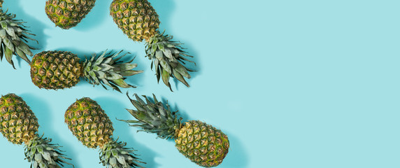 Set of fresh pineapple on blue background. Top view. Copy space. Summer background.
