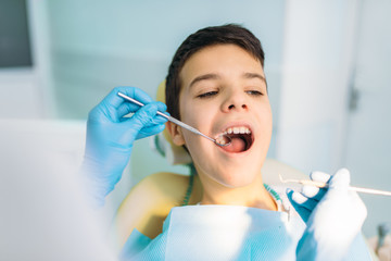 Boy with open mouth in a dental chair