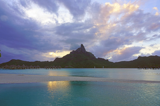 View of the Mont Otemanu mountain reflecting in water at sunset in Bora Bora, French Polynesia, South Pacific