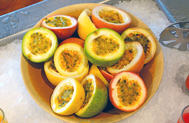 A plate of juicy passion fruit cut in half