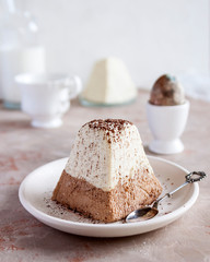 Traditional Russian Easter cottage cheese dessert, Orthodox Paskha cheesecloth standing in ceramic plate on texture table.