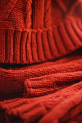 Fototapeta na wymiar Cold winter clothing - knitted red hat and scarf