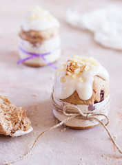 Easter background. Traditional food on the holiday table - breads with homemade raisin, cottage cheese and Easter painted eggs. Easter recipe. - Image
