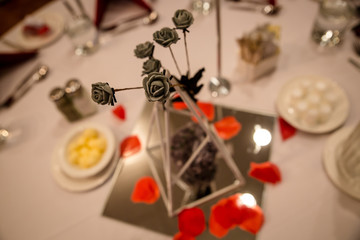 Fototapeta na wymiar Grey flower and glass table decoration