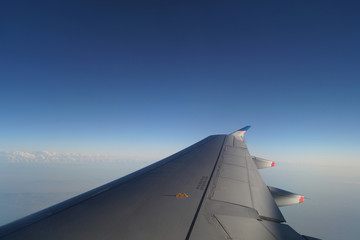 Fototapeta na wymiar airplane wing against the sky, clouds