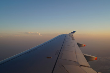 Fototapeta na wymiar airplane wing against the sky, sunset