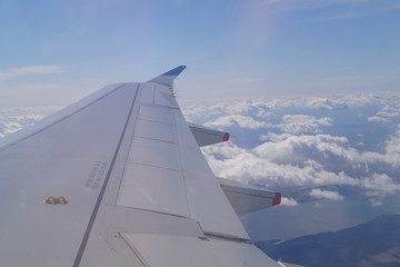 Fototapeta na wymiar airplane wing against the sky, clouds