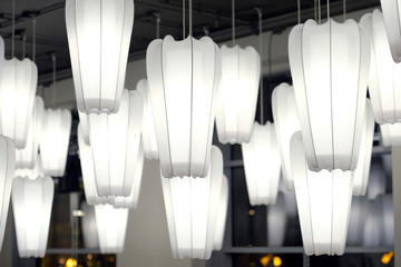 White paper lamp hanging on the ceiling in dark tone