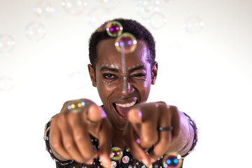 Carnaval Brazil. Face of brazilian man wearing costume. Colorful background. Carnival concept, fun and party.