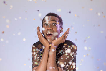 Surprised and excited. Portrait of brazilian guy dressed up for fun. Colorful background. Carnival concept, funny and party.
