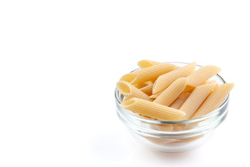 Raw feathers macaroni in bowl. Italian pasta close up, isolated on the white background
