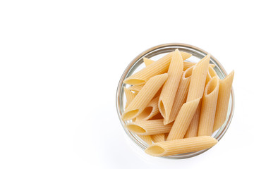Raw feathers macaroni in bowl. Italian pasta close up, isolated on the white background