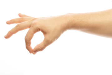 A person's hand holds an invisible object.