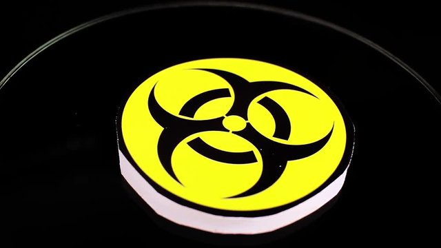 Biohazard sign symbol on rotating plate seamless looping background