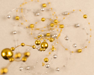 Fototapeta na wymiar Blurred background of silver and gold beads.